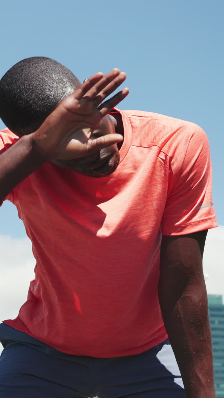Young Athlete Wiping Sweat and Resting After Intense Workout
