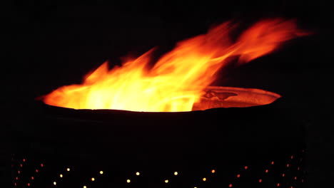 bright fire burning in a dark container