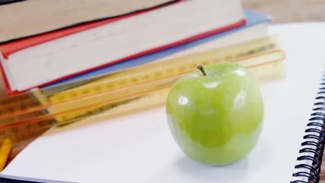 green apple on book