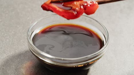 dipping marinated meat in soy sauce