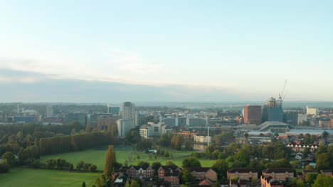 rising aerial shot of reading uk at sunrise