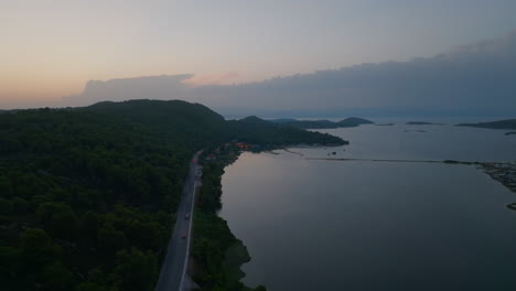 aerial view of a serene coastal road at sunset