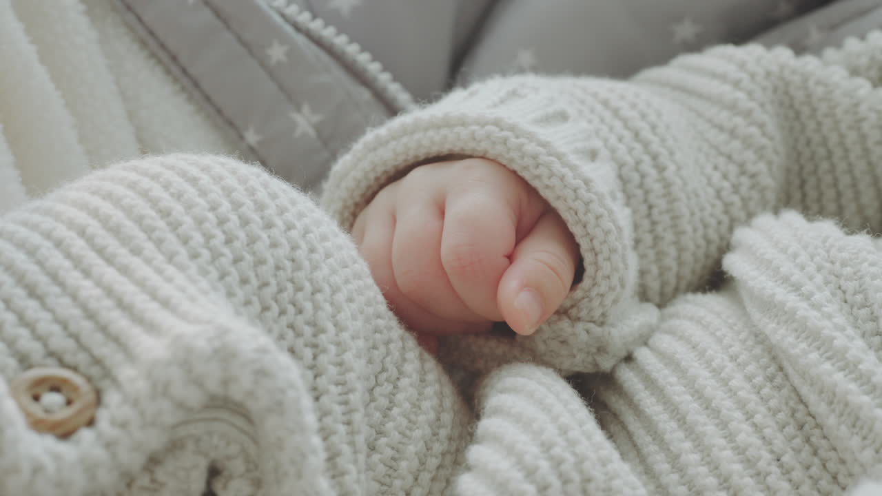 Baby's Hands in Knitted Sweater