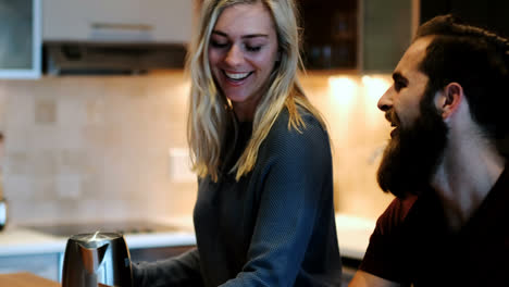 Man-using-laptop-while-woman-preparing-coffee-4k