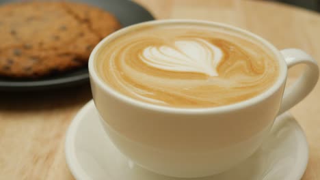 latte with heart foam art and cookie