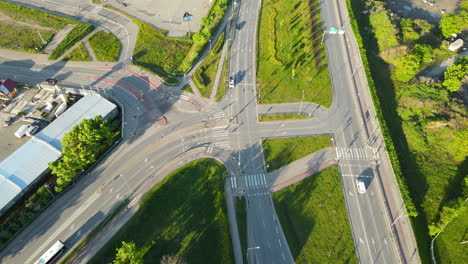 bus and cars moving along the complicated road intersection in gdansk poland, top-down view aerial