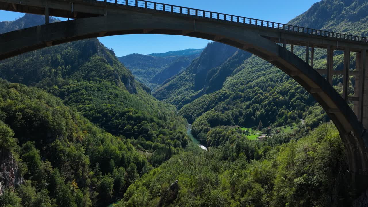 Durdevica Tara Bridge Over The Tara River With Mountains Covered In Green Forest In Montenegro. - aerial shot