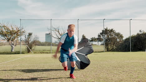 boy runs with parachute for speed and exercise