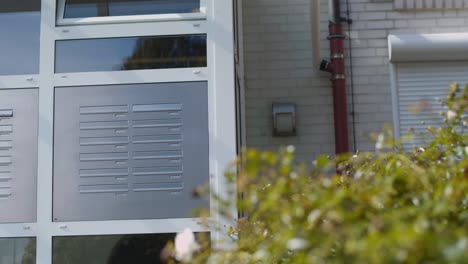 slow tracking shot showing many mailboxes of an apartment building