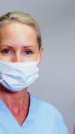 smiling dental assistant holding dental tool in clinic