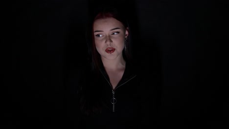 attractive young singer performing in the moon light in front of black background