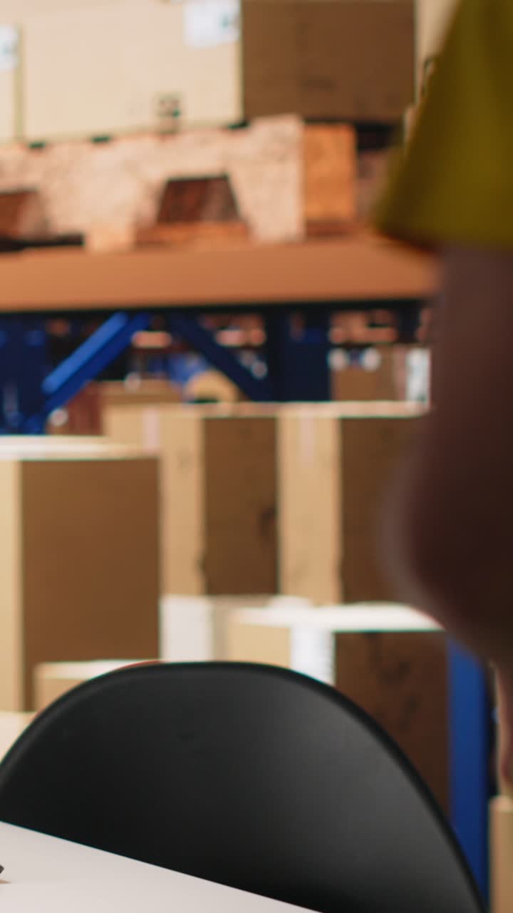 Vertical Video Warehouse worker scanning airway bills labels applied on cargo packages