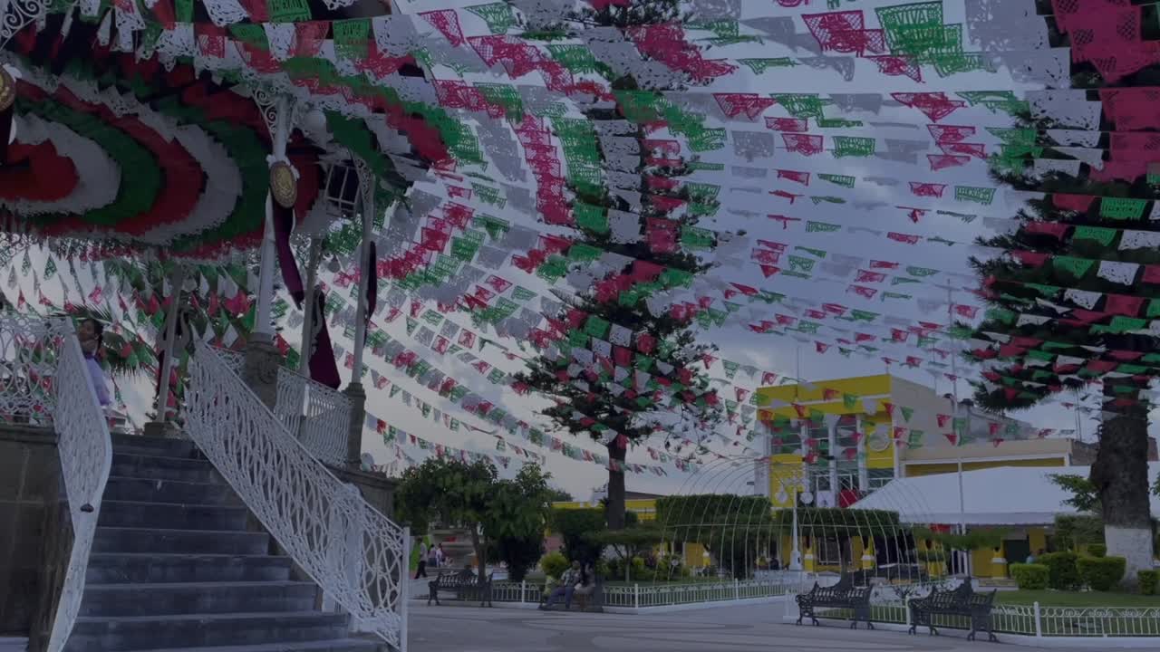 Establishing shot of Quiosco de Tuxpán decorated on Independance day with papel picado
