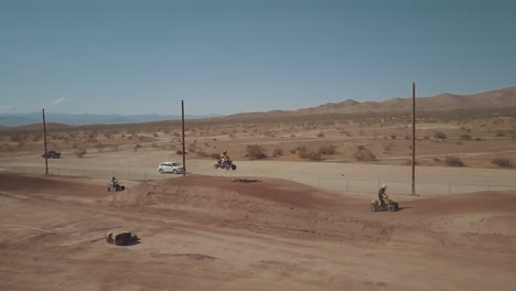 atv racing on a dirt track in california city on a spring day, aerial