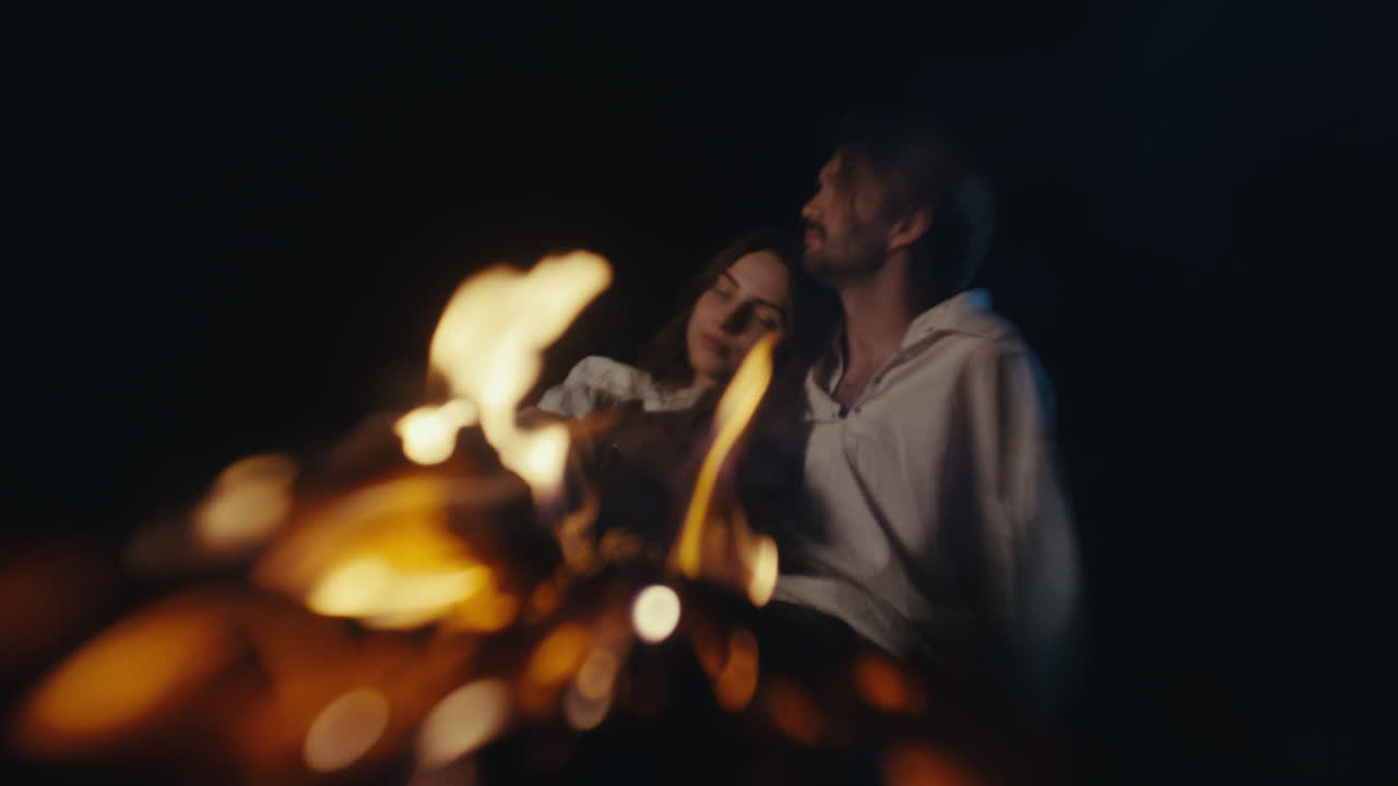 Couple by Campfire at Night