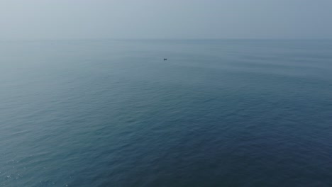 Aerial-Slow-Motion-Drone-view-of-Small-Fishing-Boat-at-El-Tunco-El-Salvador