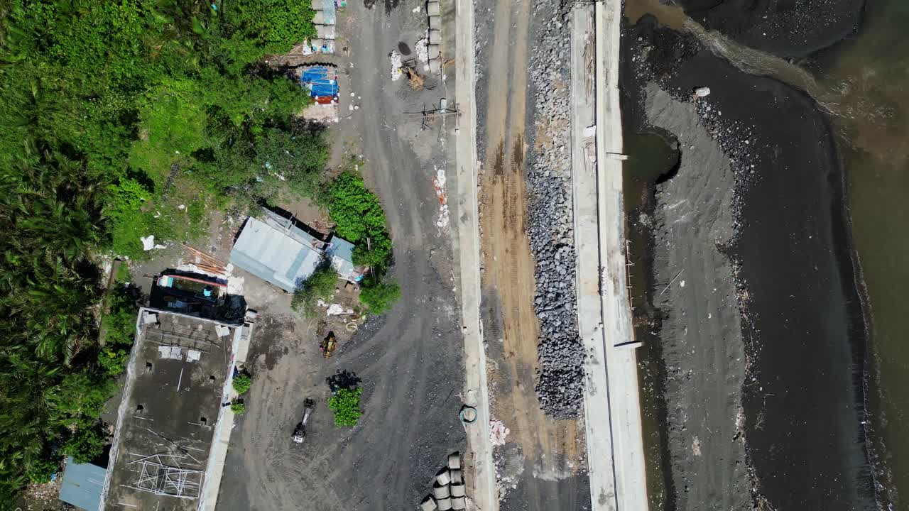 Excavator Working At Construction Site Of Malilipot Seawall In Albay, Bicol. - aerial overhead shot