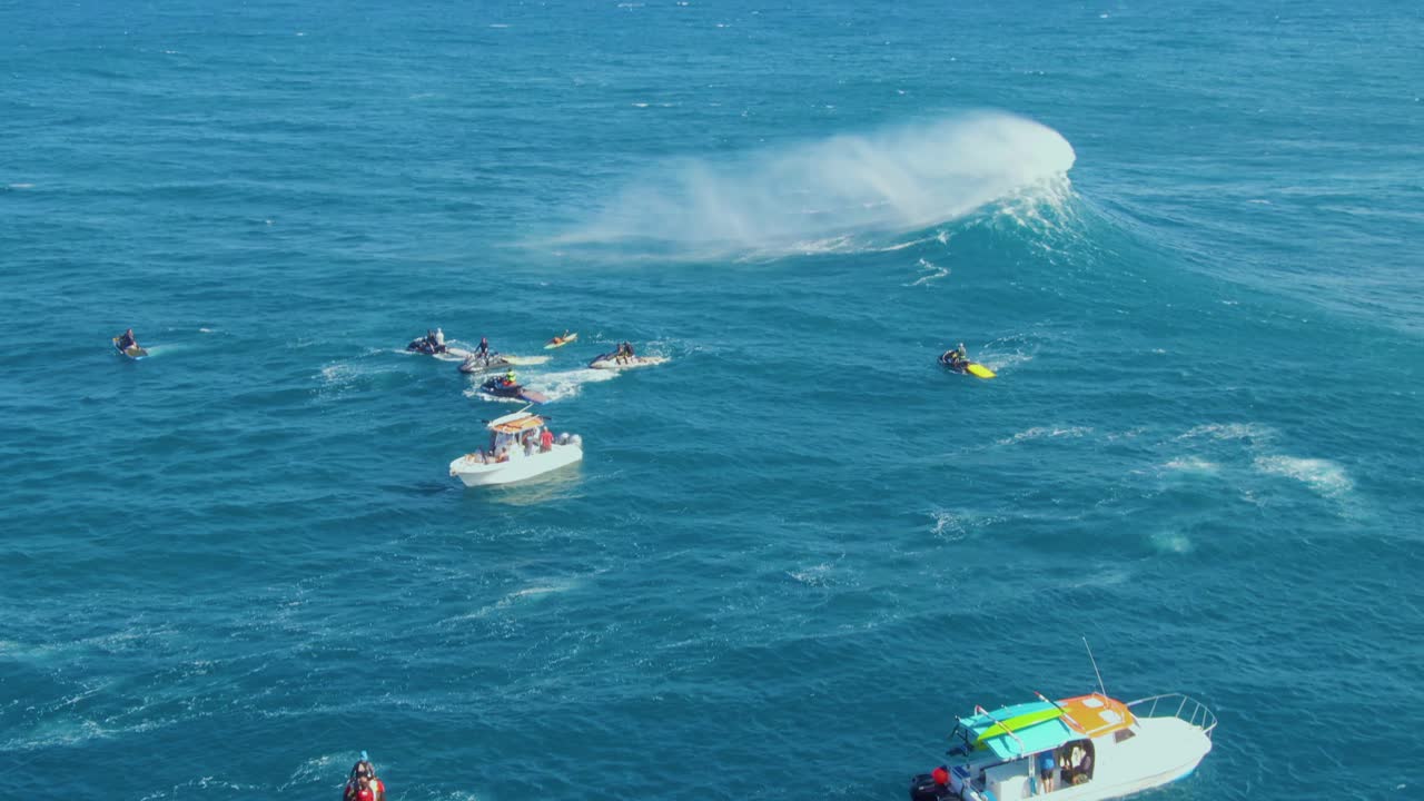 Lifeguards with speedboats making sure the surf competition taking place on coastline of Hawaii