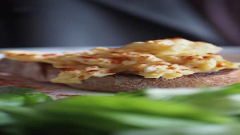 scrambled eggs on toast with paprika and greens