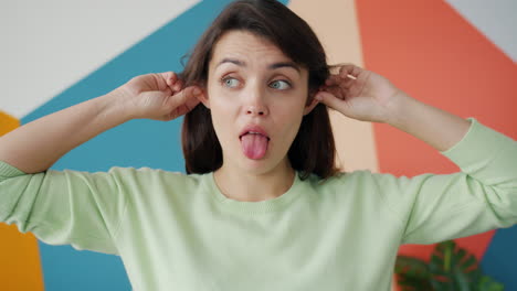 woman pulling ears, surprised expression