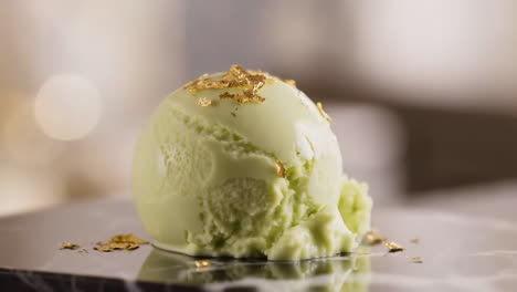 gourmet green ice cream scoop with gold flakes