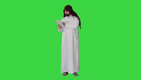arabic business man with tablet on a green screen, chroma key
