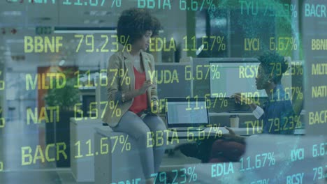animation of trading board and globe over diverse female coworkers sharing ideas on desk in office