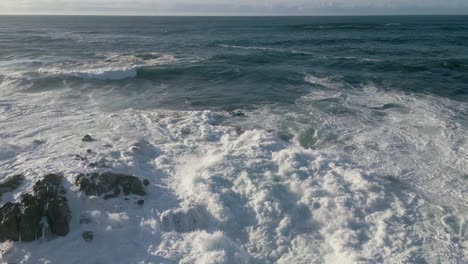 rough ocean waves rolling in foamy surface in ponteceso, corme coruna, galicia, spain