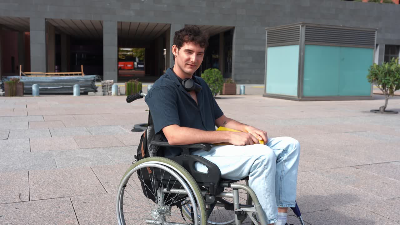 Young Man in Wheelchair Sitting Outdoors Looking at Camera