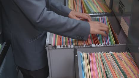 staff are searching documents in filing cabinets at the office.