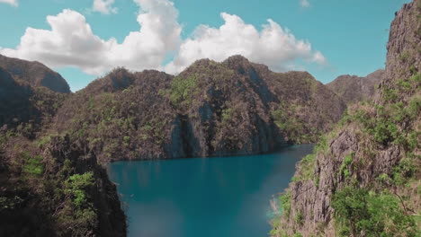 aerial reveal shot of a beautiful lagoon during a clear sunny day in el nido palawan