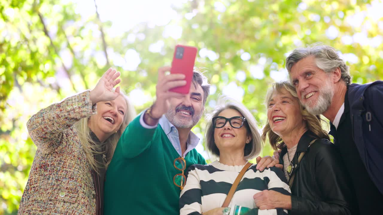 Group of senior adults taking a selfie outdoors