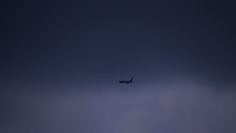 airplane flying in a dark cloudy sky