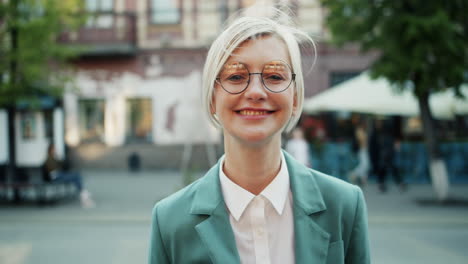smiling woman in green blazer