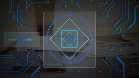 Futuristic HUD overlay being displayed over blurred desk with concentric shapes, circuit lines