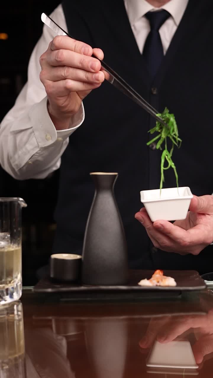 Bartender preparing a sushi dish at a bar
