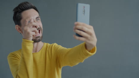 man making funny selfies