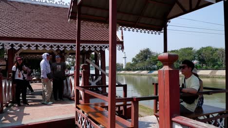 people boarding a cable car by the river