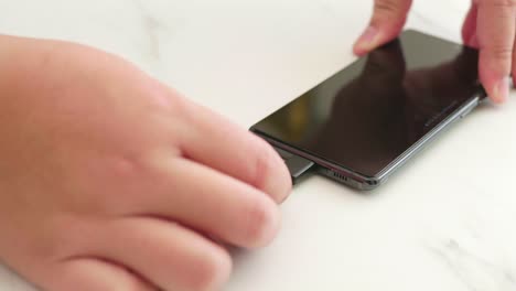 close-up of disconnect charging connection to smartphone usb-c port