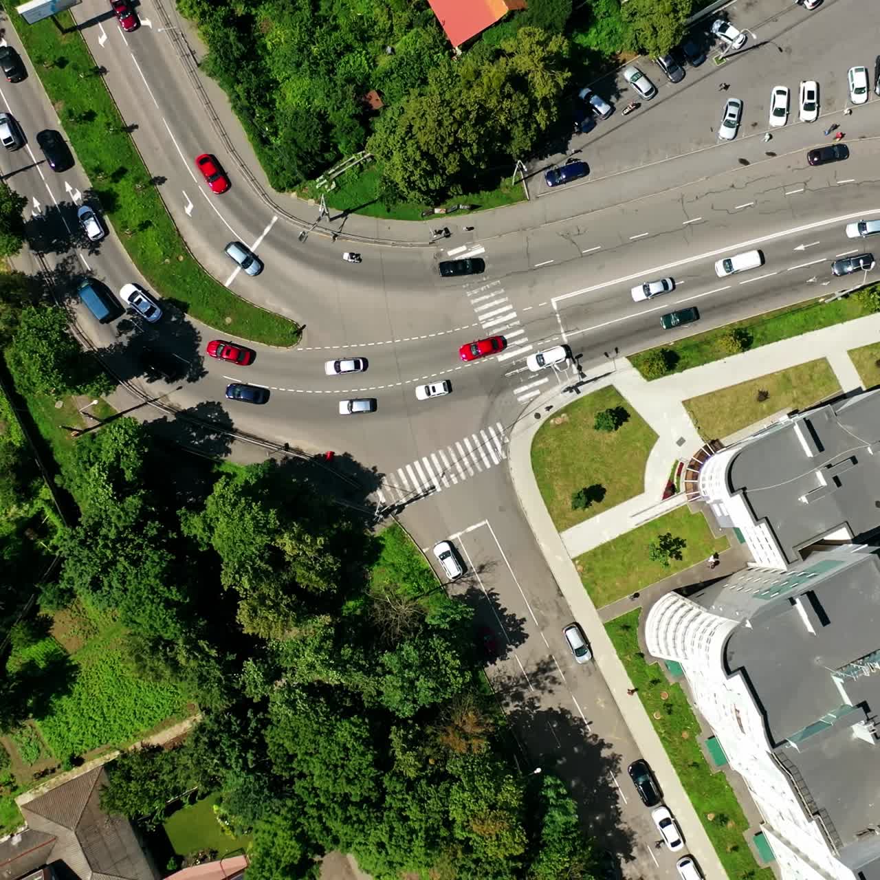 Traffic in the city. Cars moving and standing on parking zone in modern city. Car traffic and parking concept. City filled with cars. City ecology. Aerial view.