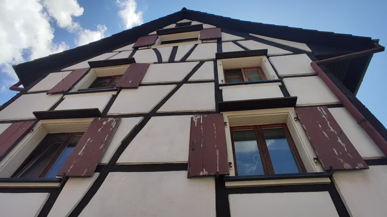 Sundgau, Alsace, France. Traditional half timbered houses of an Alsatian Village. Tilt-up shot of house.