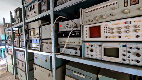 rows of vintage electronic and test equipment on shelves
