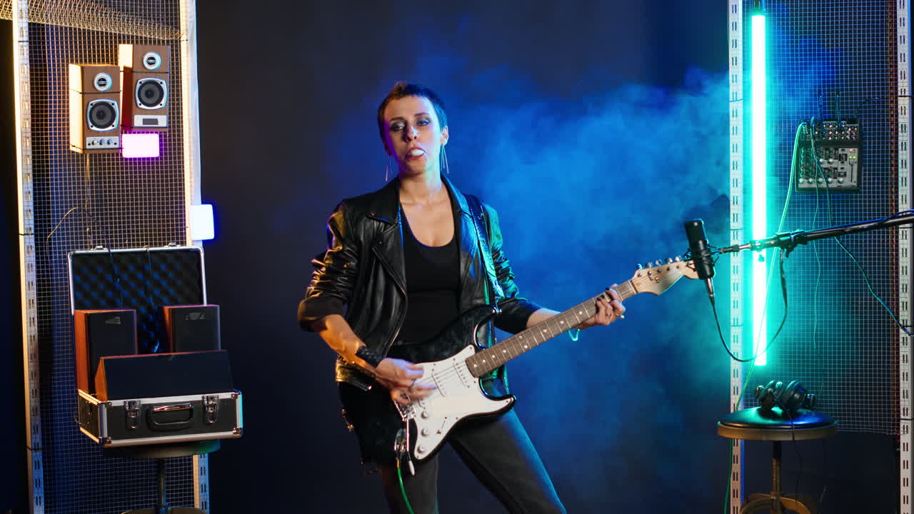 Woman performing with an electric guitar in a studio