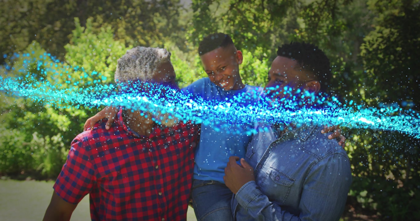 Three men holding child outdoors, blue particle wave sweeping across frame masking faces for tech
