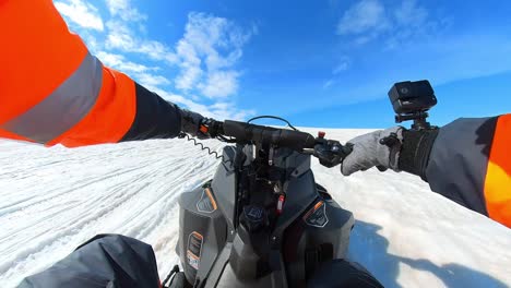 first person driving a snowmobile