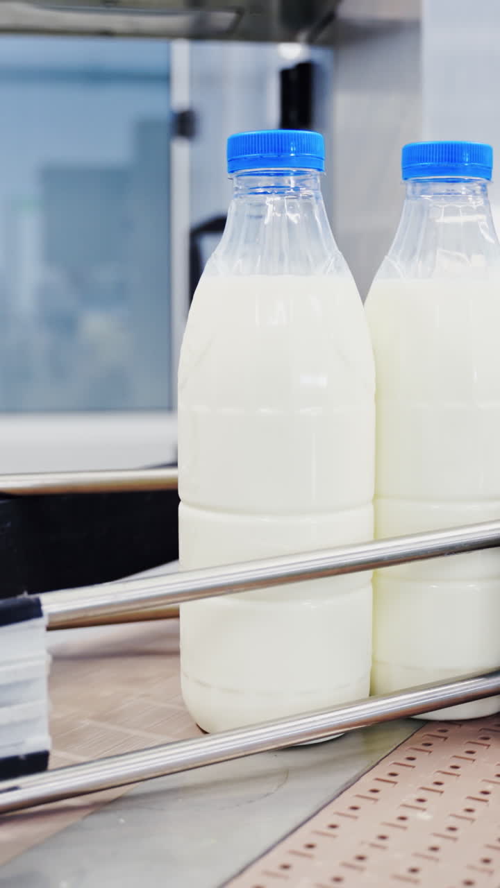 Milk production at factory. Milk production on line at the factory Vertical video