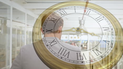 animation of clock with fast moving hands over caucasian businessman talking on smartphone