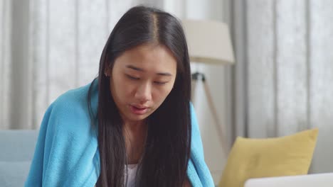 woman drinking hot beverage while resting at home