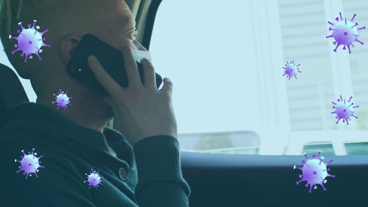 Animation of virus cells over albino african american businessman talking on smartphone