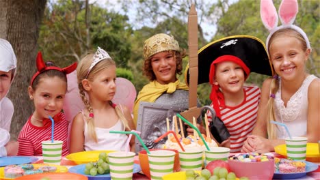 group of kids in various costumes having breakfast